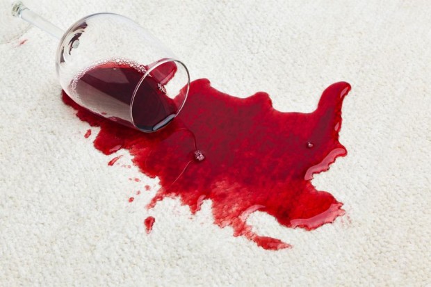 The first step to getting red wine out of your area rugs is to blot the area with a towel.